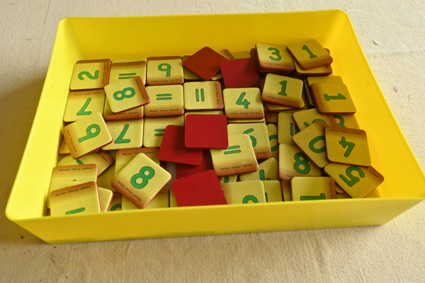 A box, with the lid removed, with a section of digit and symbol cards